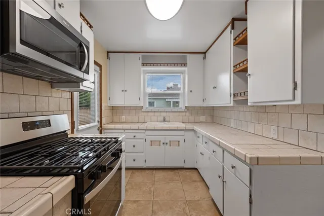 a kitchen with a stove microwave and sink