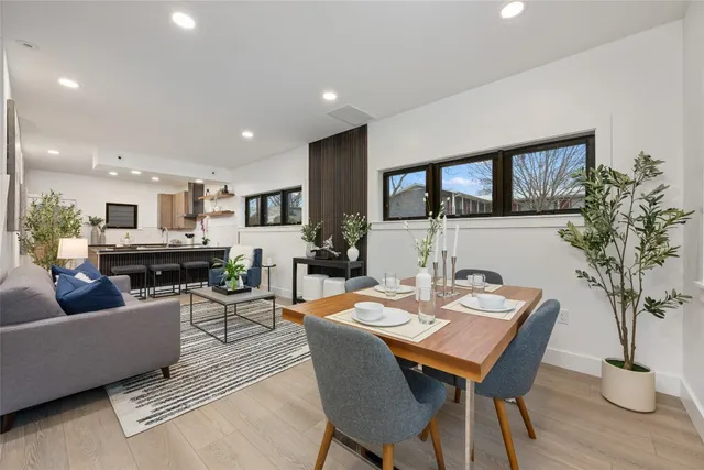 a view of a dining room with furniture and a potted plant