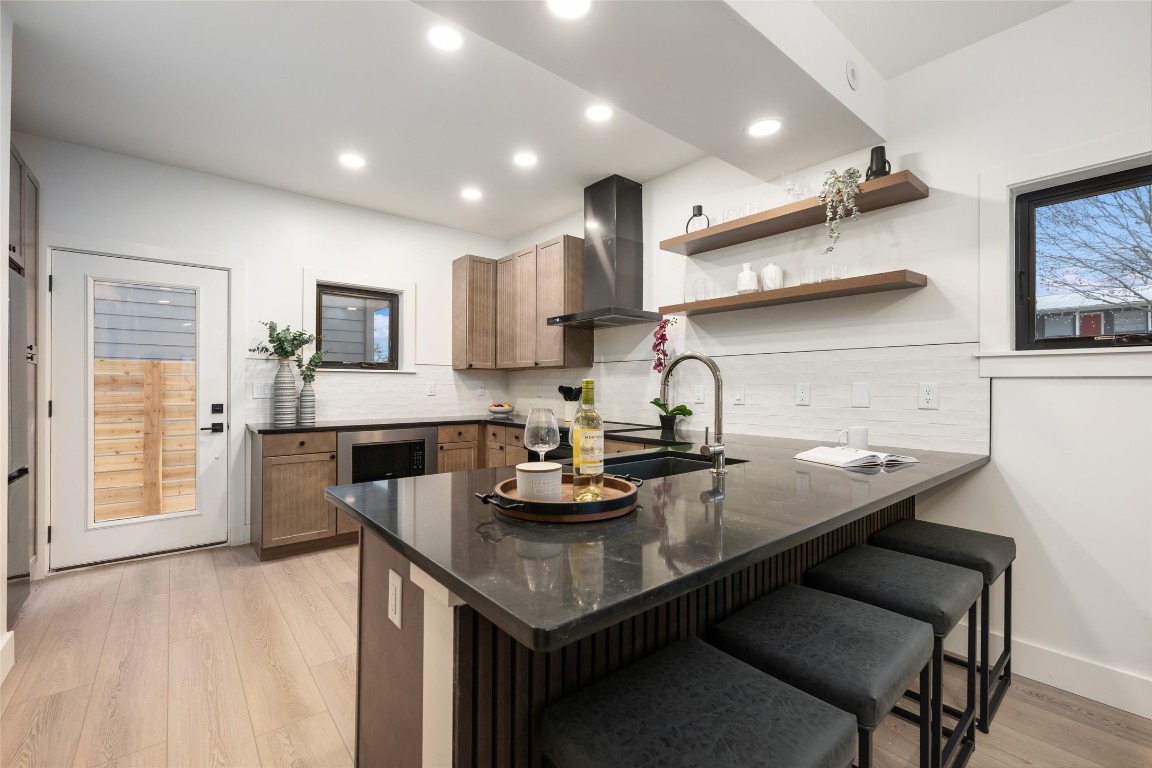6309 Walnut Hills Drive, Unit B Austin, TX 78723 - Photo 4 of 12 a kitchen with a sink a stove and chairs