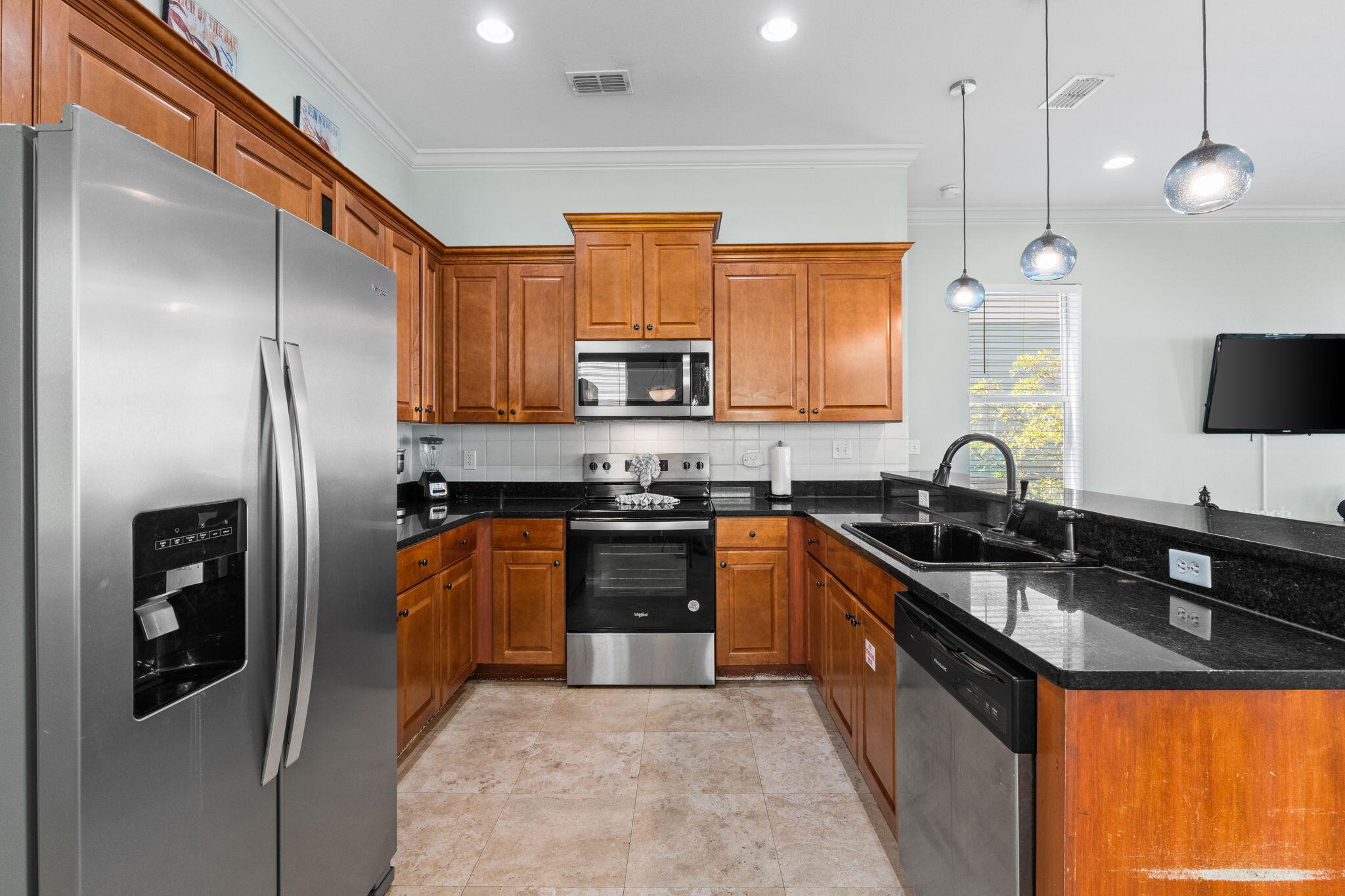 209 Grand Key Loop East Destin, FL 32541 - Photo 7 of 59 a kitchen with stainless steel appliances granite countertop a sink a stove and a refrigerator