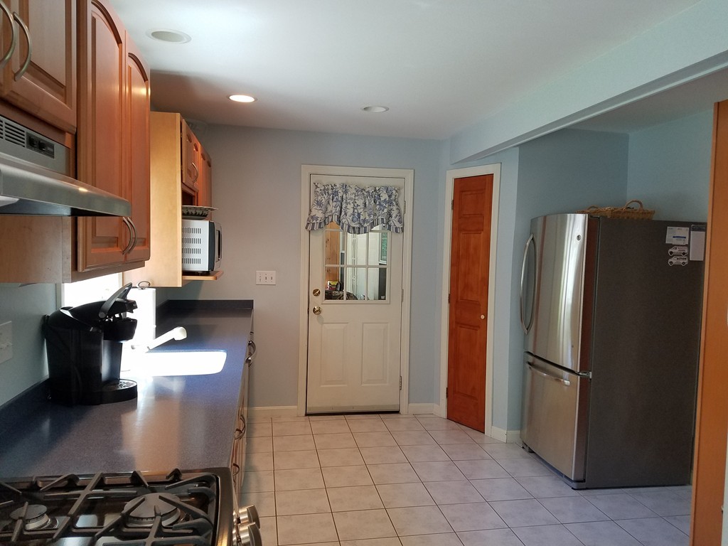110 Hunt Road Chelmsford, MA 01824 - Photo 7 of 26 a kitchen with a refrigerator and a stove