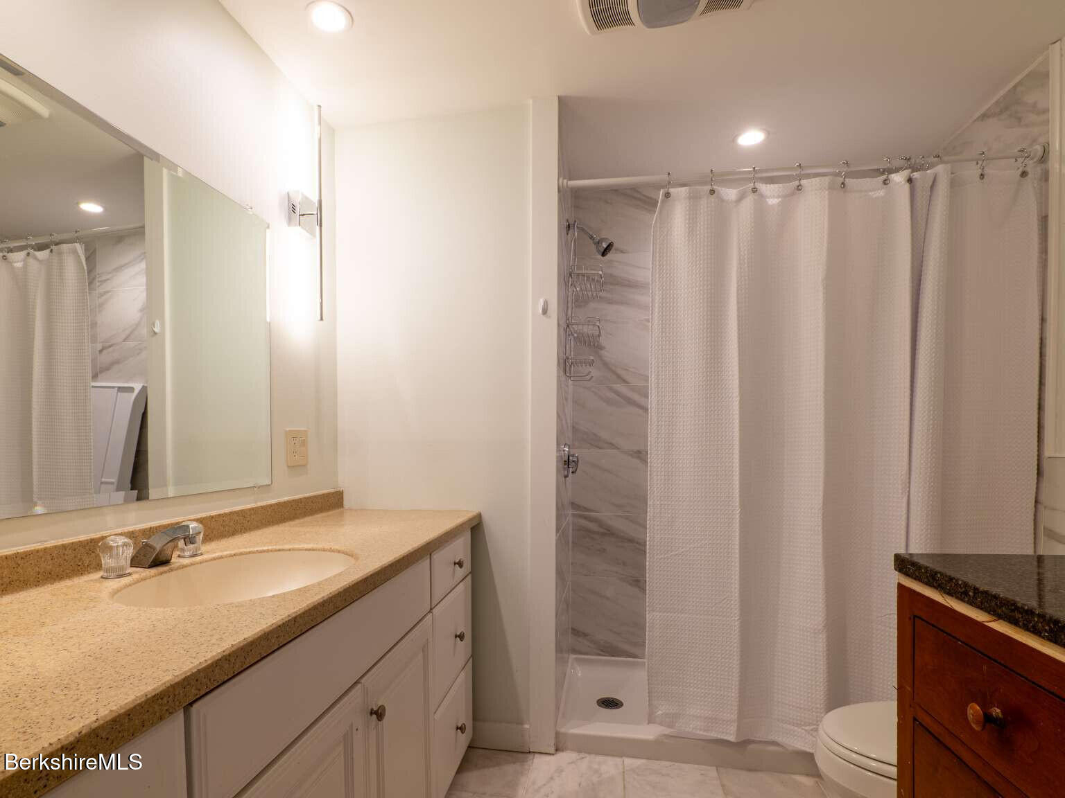 160 High Street Lee, MA 01238 - Photo 12 of 41 a bathroom with a double vanity sink and mirror