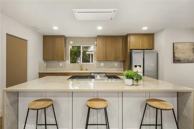 a kitchen with stainless steel appliances a refrigerator and a sink