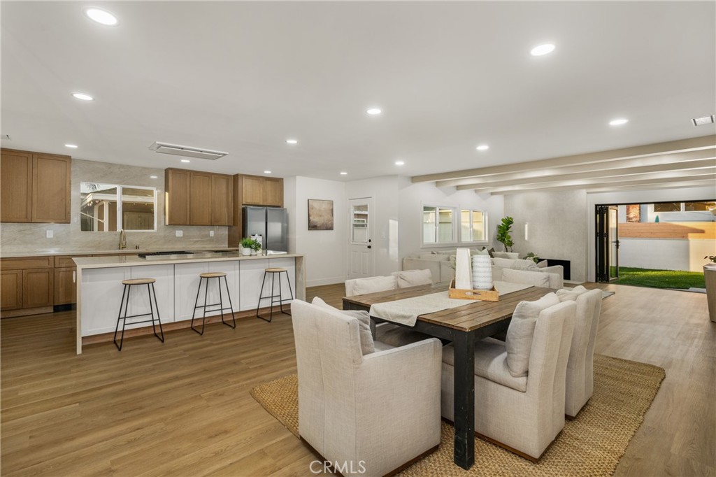 3731 Senasac Avenue Long Beach, CA 90808 - Photo 2 of 42 a open kitchen with stainless steel appliances kitchen island granite countertop a table chairs sink and cabinets