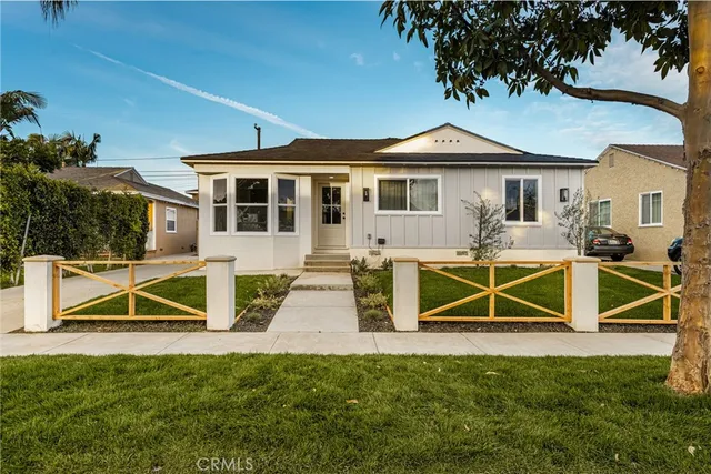 a view of a house with a yard and sitting area