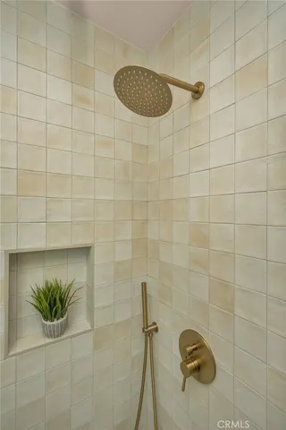 a bedroom with a bed and a potted plant