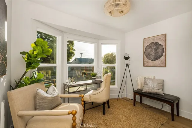 a living room with a fireplace and a floor to ceiling window