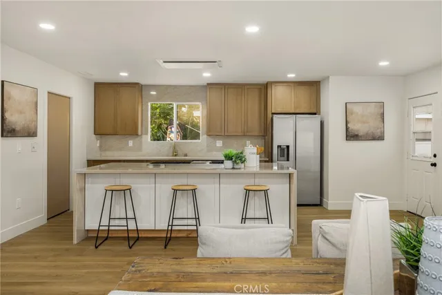 a large kitchen with a table and chairs