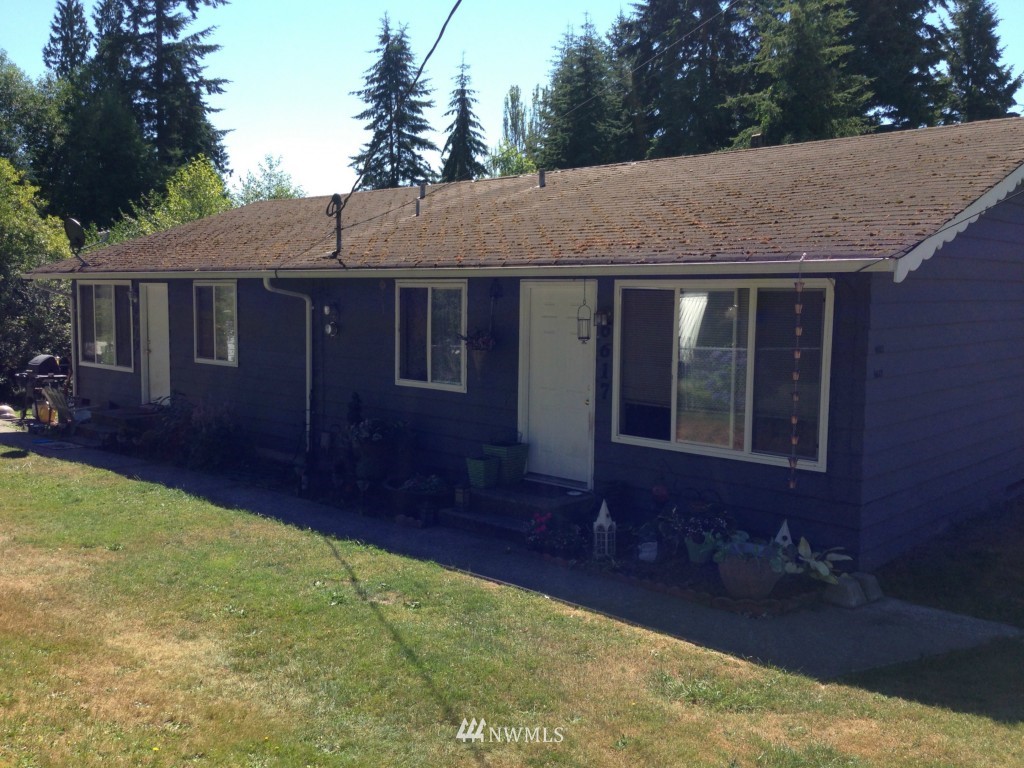 6617 Tyee Road Everett, WA 98203 - Photo 1 of 3 a front view of house with yard and trees in the background