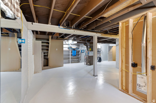 1925 South Main Street Bountiful, UT 84010 - Photo 24 of 48 Unfinished lower level featuring exposed ceiling joists, white painted concrete flooring, and a partial wood stud wall framing