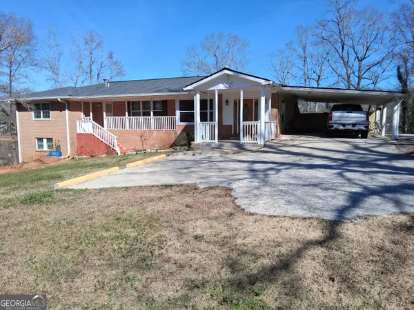 a view of large house with a yard and balcony