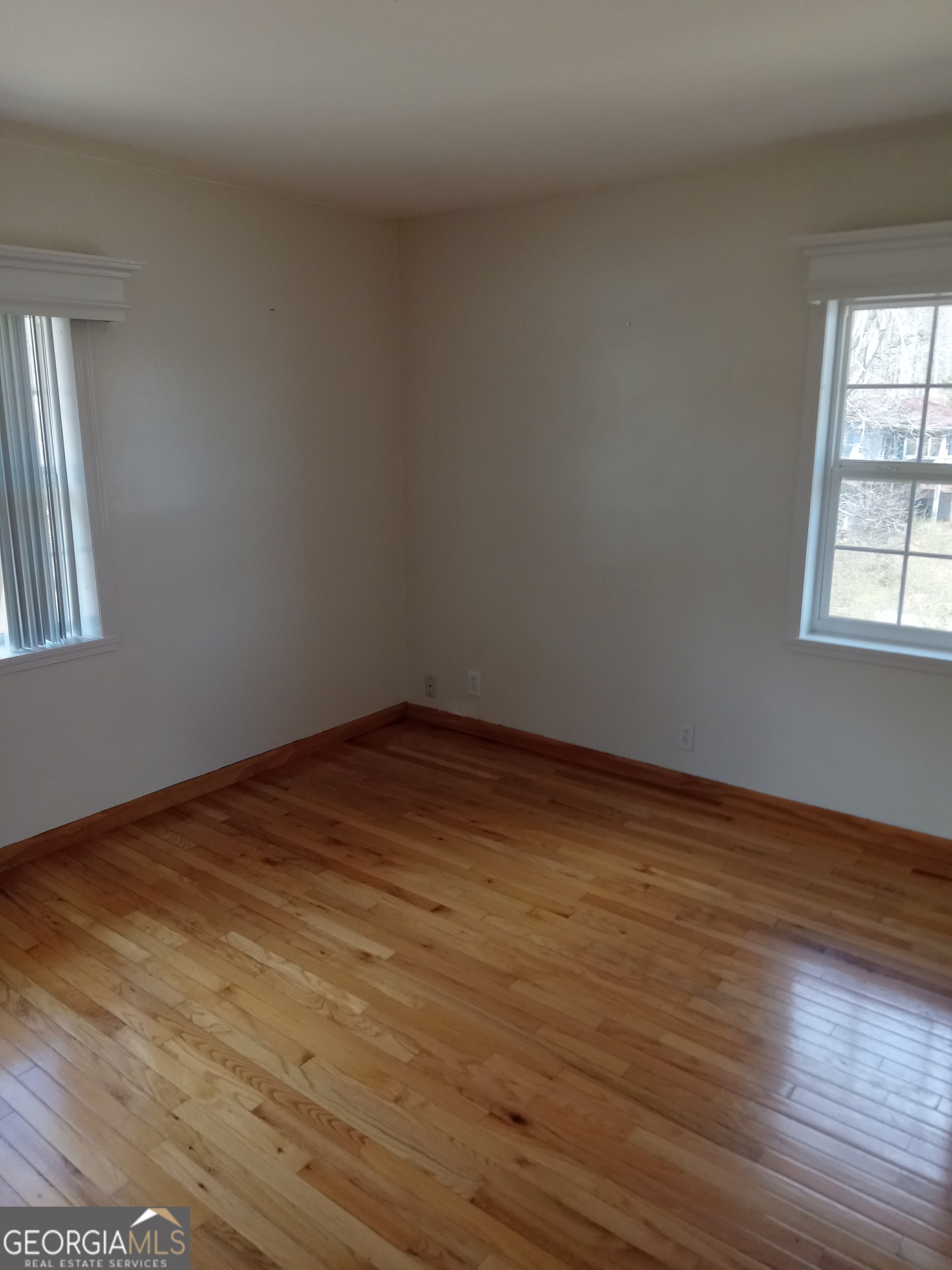 148 West James Circle Hampton, GA 30228 - Photo 13 of 13 a view of empty room with wooden floor and fan