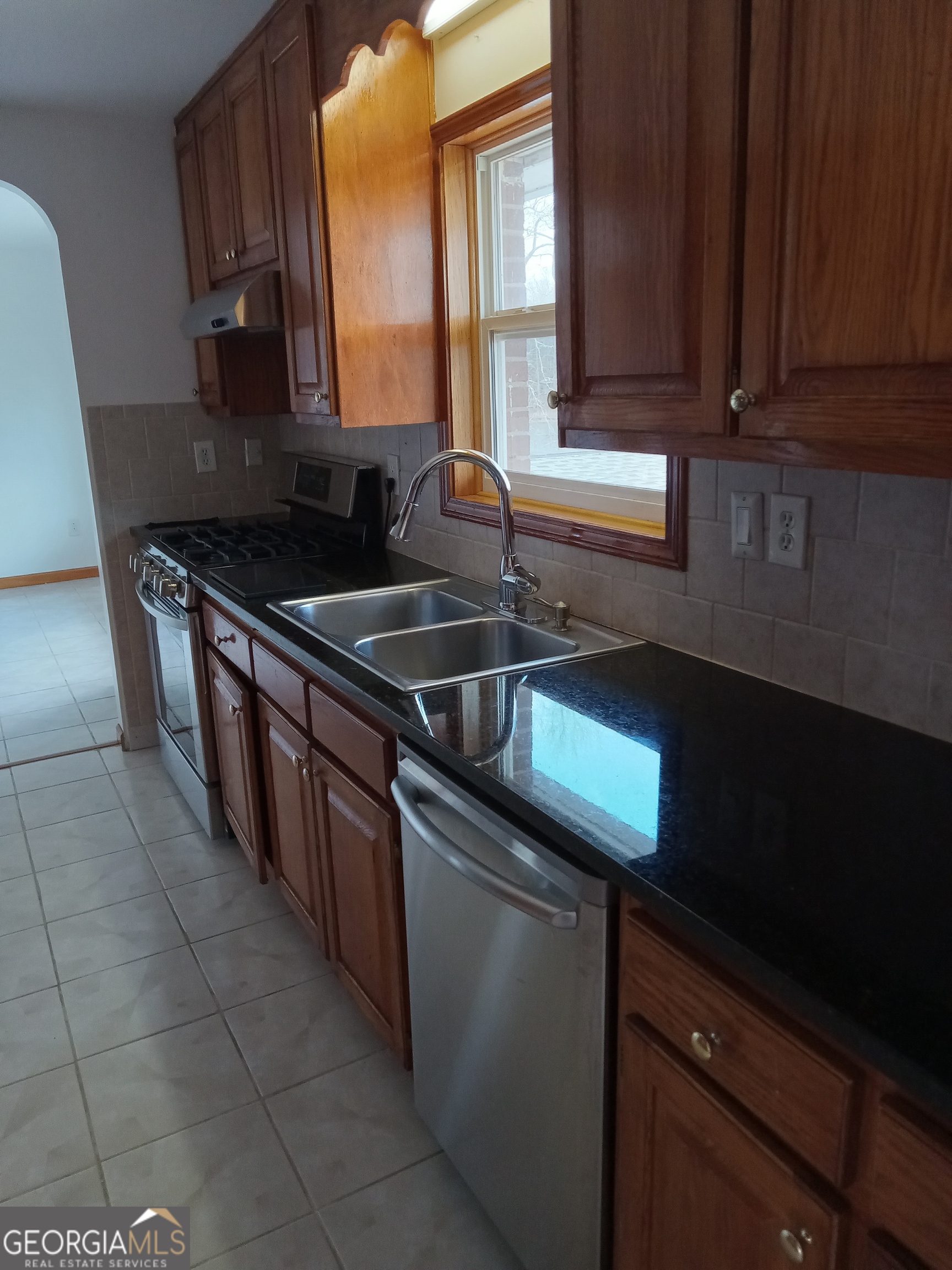 148 West James Circle Hampton, GA 30228 - Photo 5 of 13 a kitchen with stainless steel appliances granite countertop a sink stove and cabinets