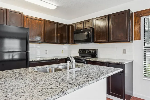 a kitchen with metallic refrigerator and countertop
