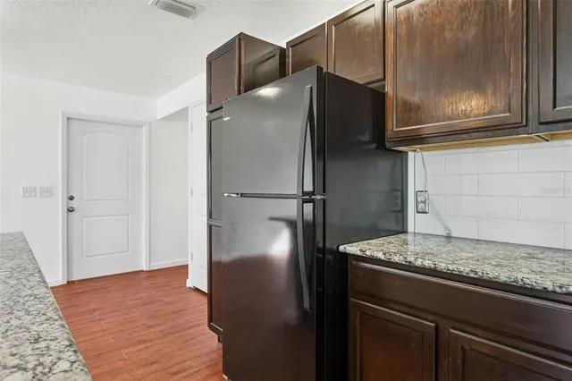 a view of a kitchen with wooden floor and a sink