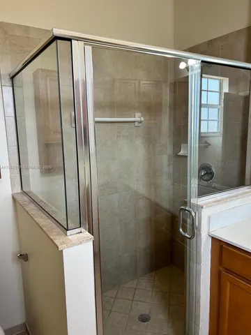 a bathroom with a glass shower door