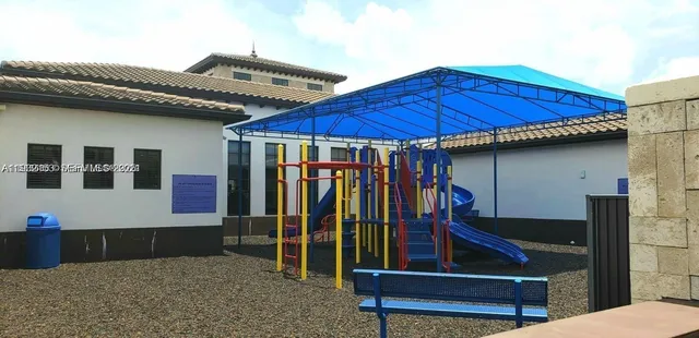 a view of a house with backyard and deck