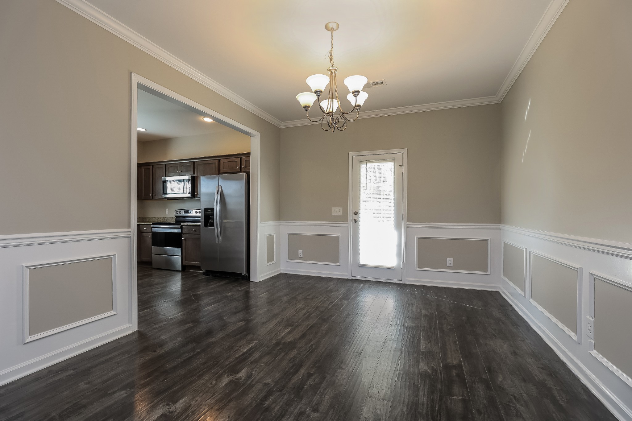 901 Beverly Court Spring Hill, TN 37174 - Photo 4 of 12 a view of a hallway with wooden floor and a kitchen