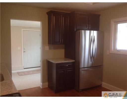 23 Colton Road Edison, NJ 08817 - Photo 5 of 12 a kitchen with a refrigerator and cabinets