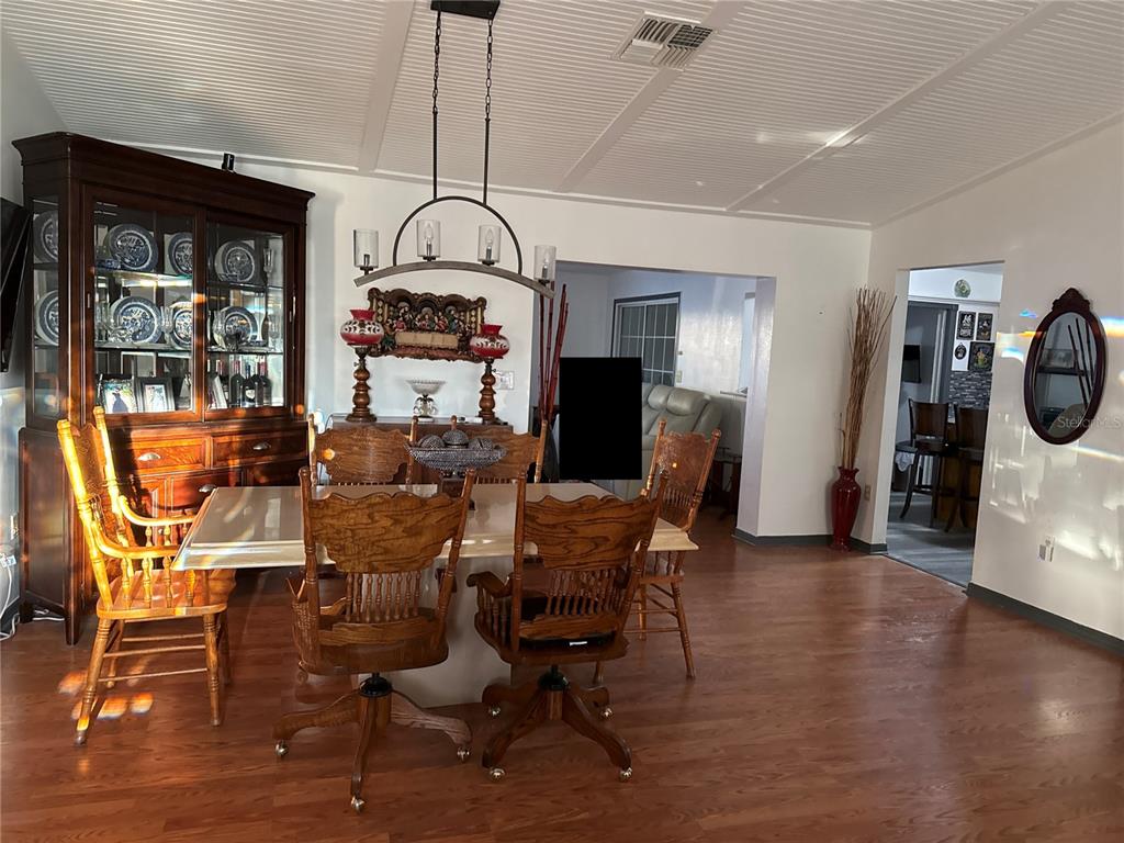 4560 Lamson Avenue Spring Hill, FL 34608 - Photo 11 of 41 a view of a dining room with furniture window and wooden floor