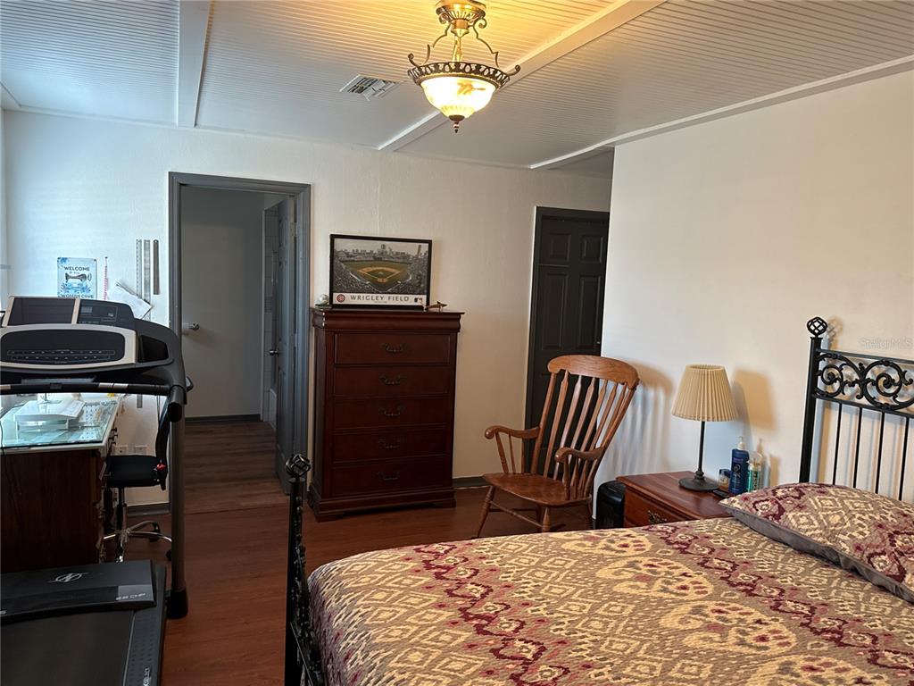 4560 Lamson Avenue Spring Hill, FL 34608 - Photo 16 of 41 a bedroom with a bed and a chandelier