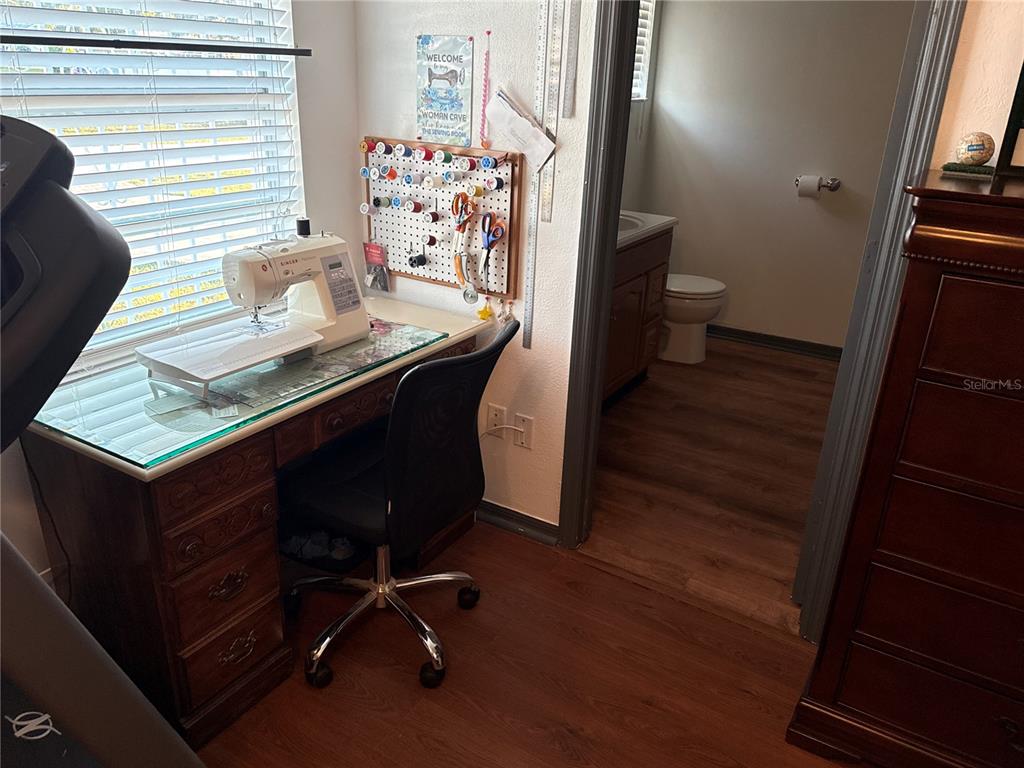4560 Lamson Avenue Spring Hill, FL 34608 - Photo 17 of 41 a view of a workspace with furniture and wooden floor
