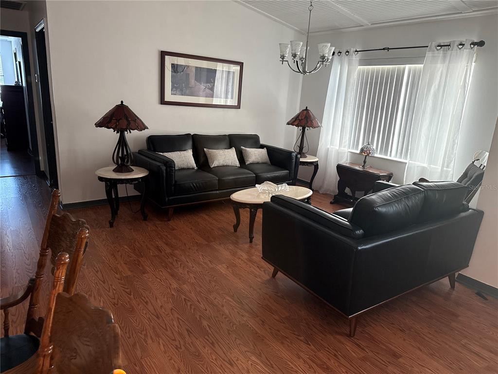 4560 Lamson Avenue Spring Hill, FL 34608 - Photo 2 of 41 a living room with furniture and a wooden floor