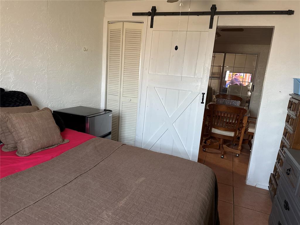 4560 Lamson Avenue Spring Hill, FL 34608 - Photo 30 of 41 a bedroom with a bed and a mirror