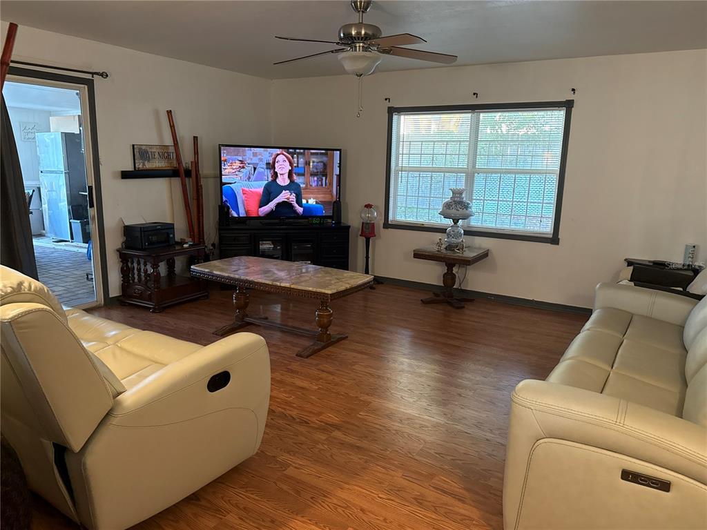4560 Lamson Avenue Spring Hill, FL 34608 - Photo 31 of 41 a living room with furniture and a flat screen tv