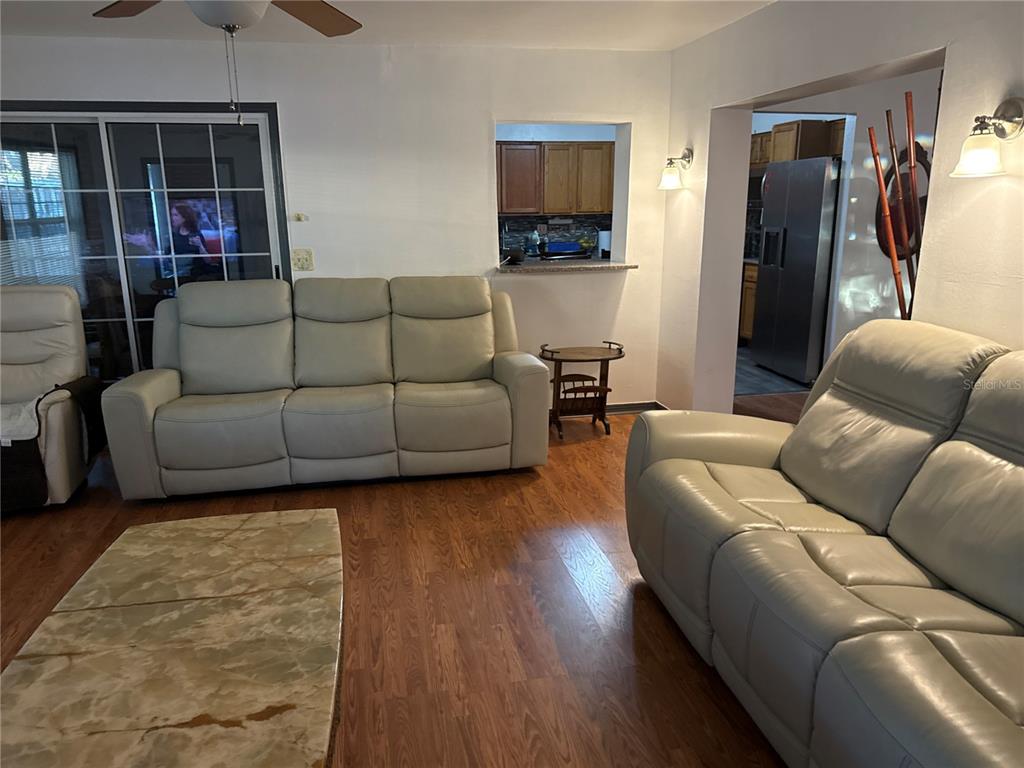 4560 Lamson Avenue Spring Hill, FL 34608 - Photo 32 of 41 a living room with furniture and a flat screen tv
