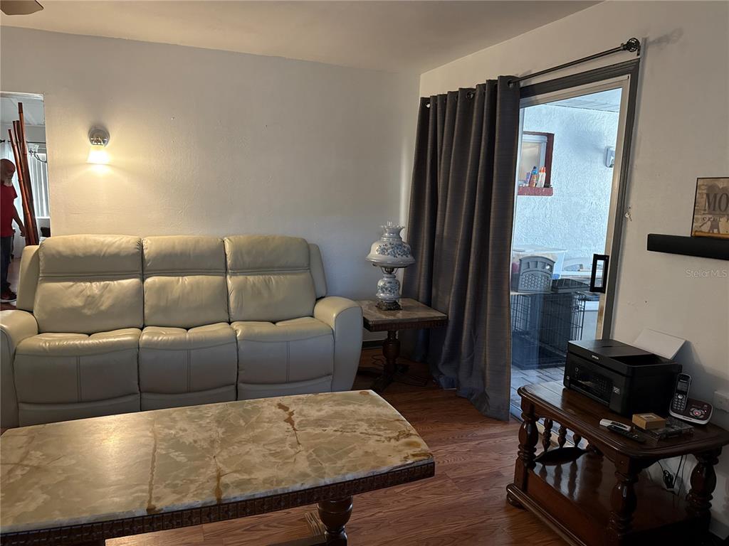 4560 Lamson Avenue Spring Hill, FL 34608 - Photo 33 of 41 a living room with furniture and a flat screen tv