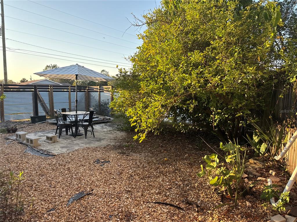 4560 Lamson Avenue Spring Hill, FL 34608 - Photo 38 of 41 a view of a patio with table and chairs and potted plants