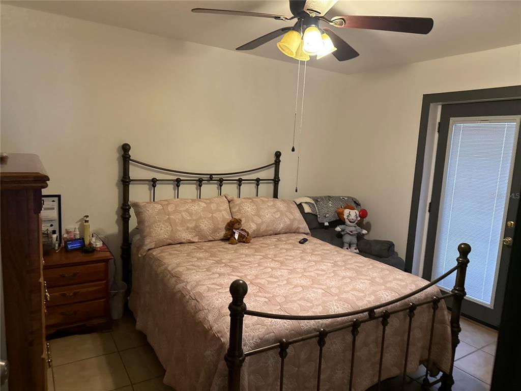 4560 Lamson Avenue Spring Hill, FL 34608 - Photo 6 of 41 a dining room with furniture and a chandelier fan