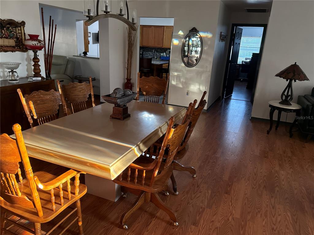4560 Lamson Avenue Spring Hill, FL 34608 - Photo 10 of 41 a dining room with furniture and wooden floor