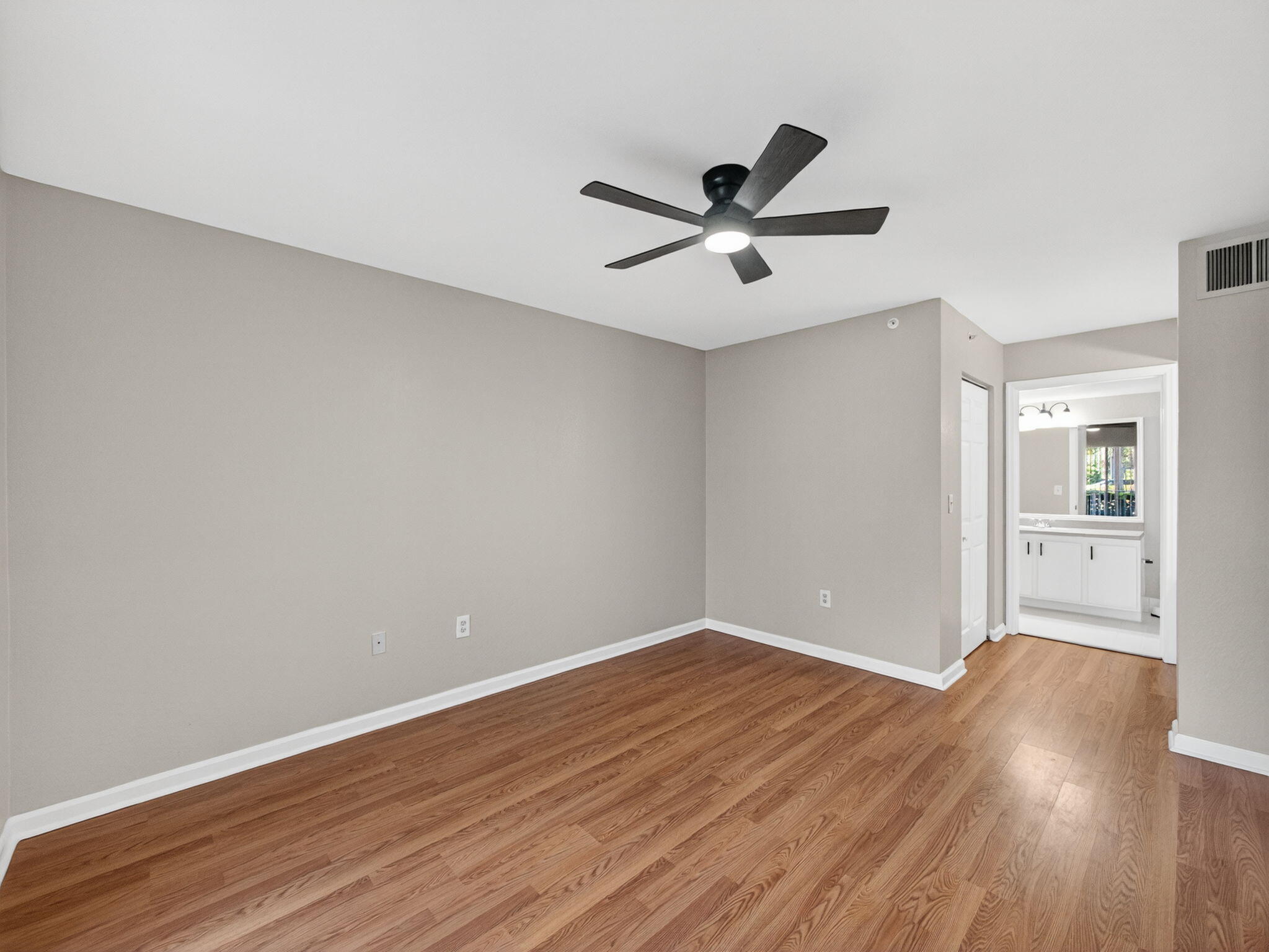 121 Southwest Palm Drive, Unit 107 Port St. Lucie, FL 34986 - Photo 9 of 15 a view of empty room with wooden floor
