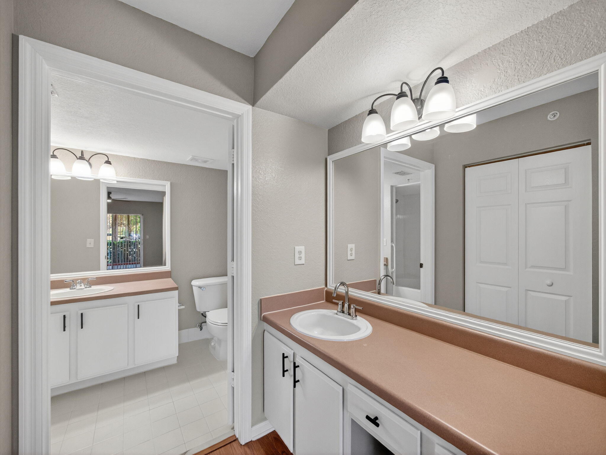 121 Southwest Palm Drive, Unit 107 Port St. Lucie, FL 34986 - Photo 10 of 15 a bathroom with a sink a light fixture and a mirror