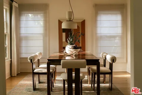 a kitchen with stainless steel appliances kitchen island granite countertop a sink stove and refrigerator