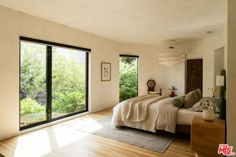a hallway with sliding door and front door