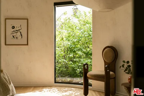 a view of a balcony with wooden floor and fence