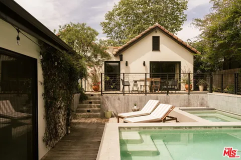 a view of a patio with couple of chairs