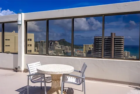 a view of a balcony dining table and chairs
