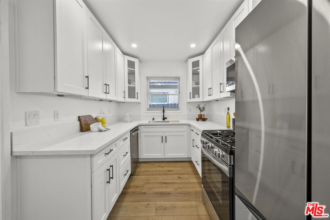 746 Valley View Avenue Monrovia, CA 91016 - Photo 12 of 53 a kitchen with white cabinets sink and stove