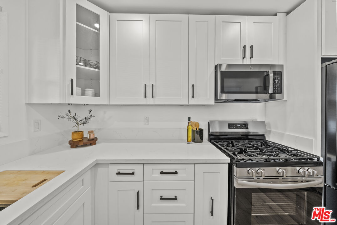 746 Valley View Avenue Monrovia, CA 91016 - Photo 15 of 53 a kitchen with white cabinets and appliances