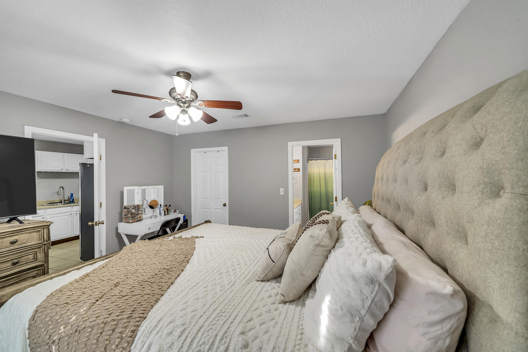 1705 North Pearl Street Crestview, FL 32536 - Photo 12 of 23 a bedroom with a large bed and a chandelier