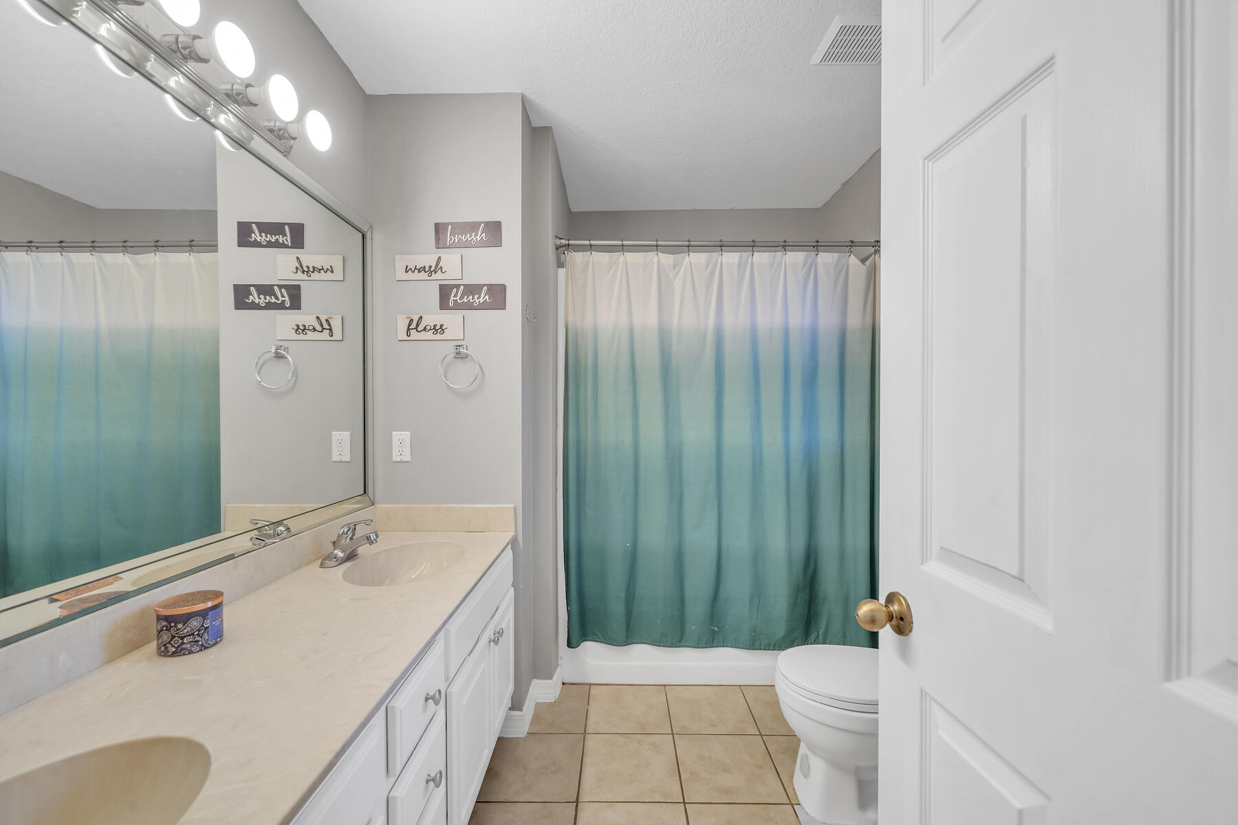 1705 North Pearl Street Crestview, FL 32536 - Photo 14 of 23 a spacious bathroom with a granite countertop sink a toilet and shower