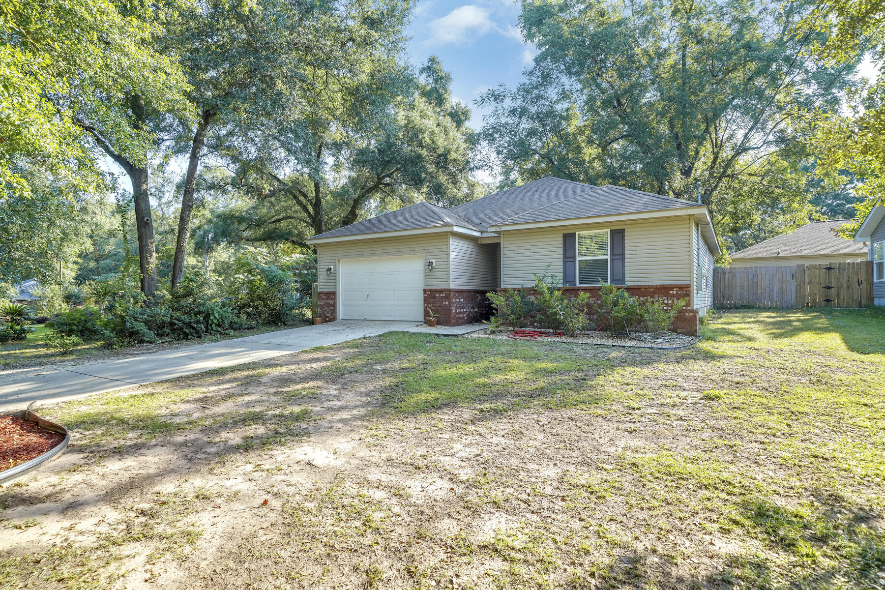 1705 North Pearl Street Crestview, FL 32536 - Photo 3 of 23 a view of a house with a yard and potted plants