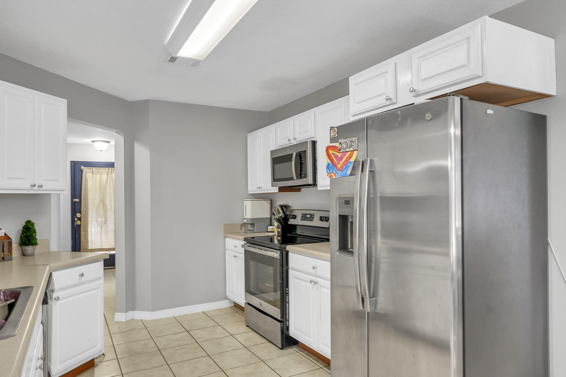 1705 North Pearl Street Crestview, FL 32536 - Photo 9 of 23 a kitchen with stainless steel appliances a refrigerator stove and sink