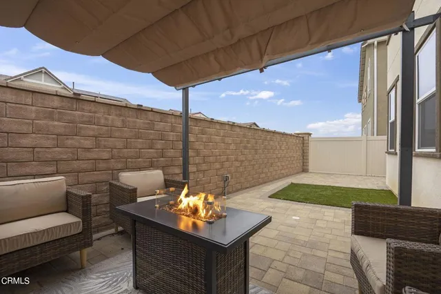 a backyard of a house with outdoor seating