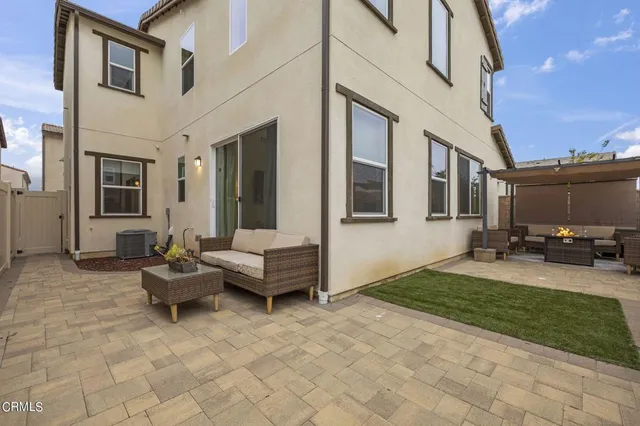 a view of a house with backyard and sitting area