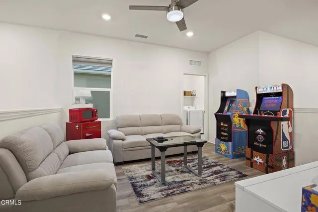 a living room with furniture a flat screen tv and a fireplace